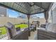 Cozy backyard under gazebo with comfortable seating and a grill perfect for summer evenings at 4060 N Rome St, Aurora, CO 80019