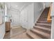 Bright entryway with wood floors, a staircase, and white walls leading to other parts of the home at 4060 N Rome St, Aurora, CO 80019