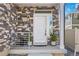 Charming front porch with stone accents, a white door, and stylish potted plants adding to the curb appeal at 4060 N Rome St, Aurora, CO 80019