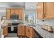 Modern kitchen with stainless steel appliances, wood cabinets, and granite countertops at 4060 N Rome St, Aurora, CO 80019