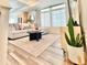 Bright living room with large windows, modern furniture, and an open layout leading into the kitchen area at 4060 N Rome St, Aurora, CO 80019