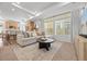 Spacious living room with a large window, comfortable seating, and an open layout connecting to the kitchen area at 4060 N Rome St, Aurora, CO 80019