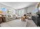 Spacious living room with a gray sofa, a patterned rug, and lots of natural light at 4060 N Rome St, Aurora, CO 80019