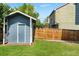 Backyard with a shed and wood fence surrounding a grass area at 9816 Garwood St, Littleton, CO 80125