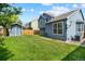 Spacious backyard with green grass, wooden fence, and storage shed at 9816 Garwood St, Littleton, CO 80125