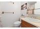 Functional bathroom featuring a white toilet, vanity with sink, and a shower-tub combination at 9816 Garwood St, Littleton, CO 80125