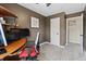 Bedroom featuring brown walls, neutral carpet, desk, white trim, and a peek into the closet at 9816 Garwood St, Littleton, CO 80125