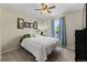 Cozy bedroom features carpet, a comfortable queen-sized bed, and natural light from a side window at 9816 Garwood St, Littleton, CO 80125