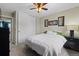 Charming bedroom with carpet, a queen-sized bed, and a closet with white sliding doors at 9816 Garwood St, Littleton, CO 80125