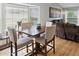 Dining area with a wood table, four chairs, large windows, and living room furniture at 9816 Garwood St, Littleton, CO 80125