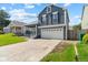 Two-story home with blue siding, white garage door, and a driveway and yard at 9816 Garwood St, Littleton, CO 80125