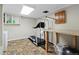 Home gym area features a treadmill, work out equipment, neutral paint, and tile flooring at 9816 Garwood St, Littleton, CO 80125