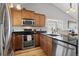 Modern kitchen with stainless steel appliances, granite countertops, and wooden cabinets at 9816 Garwood St, Littleton, CO 80125