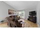 Bright living room featuring hardwood floors, large windows, and a cozy, neutral-toned sofa at 9816 Garwood St, Littleton, CO 80125