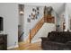 Inviting living room with staircase, wood floors, and cozy seating for entertaining or relaxing at 9816 Garwood St, Littleton, CO 80125