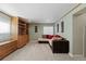 Comfortable living room with carpet flooring, built-in shelving and large couch at 9816 Garwood St, Littleton, CO 80125