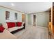 Cozy living room area with plush carpet, a comfortable sectional couch, and painted walls at 9816 Garwood St, Littleton, CO 80125