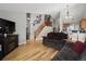 Spacious living room with staircase features a fireplace, hardwood floors, and comfortable furnishings at 9816 Garwood St, Littleton, CO 80125