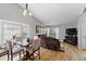Open living area features a dining table, living room furniture, and large windows at 9816 Garwood St, Littleton, CO 80125