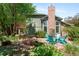 Backyard offers a lovely patio, outdoor seating, and a water feature amidst mature trees and landscaping at 2345 Spotswood Pl, Boulder, CO 80304