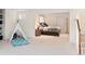 Finished basement with a bedroom, playful teepee, and ample space for recreation and relaxation at 2345 Spotswood Pl, Boulder, CO 80304