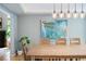 Bright dining room with hardwood floors, modern light fixtures, and a large abstract painting at 2345 Spotswood Pl, Boulder, CO 80304