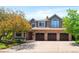 Charming two-story home with a three-car garage, brick accents, and manicured landscaping at 2345 Spotswood Pl, Boulder, CO 80304