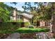 Beautiful two-story home with manicured lawn, lush landscaping, mature trees, and a brick chimney at 2345 Spotswood Pl, Boulder, CO 80304
