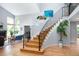 Bright foyer with hardwood floors, staircase with iron railing, and soaring ceilings at 2345 Spotswood Pl, Boulder, CO 80304