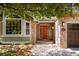 Inviting front entrance with a solid wood door, brick accents, and a well-lit walkway at 2345 Spotswood Pl, Boulder, CO 80304