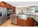 A modern kitchen features stainless steel appliances and a beautiful bay window in the background at 2345 Spotswood Pl, Boulder, CO 80304