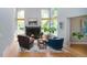Inviting living room featuring a fireplace, hardwood floors, and large windows for natural light at 2345 Spotswood Pl, Boulder, CO 80304