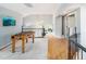 Spacious loft area with hardwood floors, foosball table, and abundant natural light from large windows at 2345 Spotswood Pl, Boulder, CO 80304