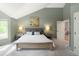 Vaulted ceiling bedroom featuring a comfortable bed, bedside tables, and an ensuite bathroom entrance at 2345 Spotswood Pl, Boulder, CO 80304