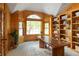Bright office space with large window and a wooden desk, complemented by custom shelving at 2345 Spotswood Pl, Boulder, CO 80304