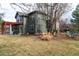 This backyard features mature trees, grass and a patio at 2345 Spotswood Pl, Boulder, CO 80304