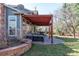 This backyard patio features a dark wood pergola and outdoor seating area at 2345 Spotswood Pl, Boulder, CO 80304