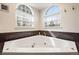 Corner soaking tub with jets surrounded by granite counter and beautiful windows at 2345 Spotswood Pl, Boulder, CO 80304