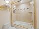 Bathroom featuring a shower over tub with glass door and gold hardware at 2345 Spotswood Pl, Boulder, CO 80304