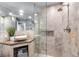 Modern bathroom featuring a stone-tiled shower, sleek vanity, and vessel sink at 2345 Spotswood Pl, Boulder, CO 80304