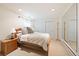 Bright bedroom with a large bed, wooden nightstand, and mirrored closet at 2345 Spotswood Pl, Boulder, CO 80304