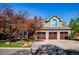 Beautiful home exterior showcasing a three-car garage, brick accents, and mature trees on a sunny day at 2345 Spotswood Pl, Boulder, CO 80304