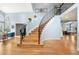 Grand foyer with hardwood flooring, staircase with iron railings, and abundant natural light at 2345 Spotswood Pl, Boulder, CO 80304