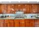 Close-up of a kitchen showcasing granite countertops, a gas cooktop, and custom wood cabinets at 2345 Spotswood Pl, Boulder, CO 80304