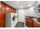 Functional laundry room with a sink, washer, dryer, and ample cabinet space for storage at 2345 Spotswood Pl, Boulder, CO 80304