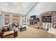 Bright living room with vaulted ceilings, brick fireplace, and large windows offering natural light at 2345 Spotswood Pl, Boulder, CO 80304