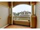 Balcony view overlooking complex with orange rug, columns, and ample outdoor space at 8369 S Independence Cir # 205, Littleton, CO 80128