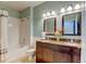 Bright bathroom featuring a double sink vanity with granite countertops and a shower over tub at 8369 S Independence Cir # 205, Littleton, CO 80128