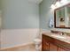 Bathroom offers a dark wood vanity with granite countertop at 8369 S Independence Cir # 205, Littleton, CO 80128