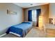 Bedroom featuring a blue bedspread with a window and a light at 8369 S Independence Cir # 205, Littleton, CO 80128